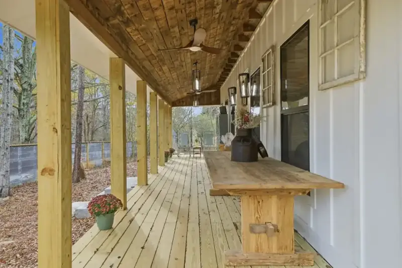 Covered wooden porch at 356 Hyde Road with a long walkway and outdoor seating