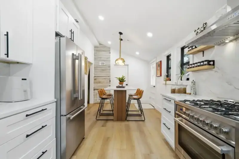 Kitchen at 356 Hyde Road with white cabinetry, stainless steel range, and dining area beyond