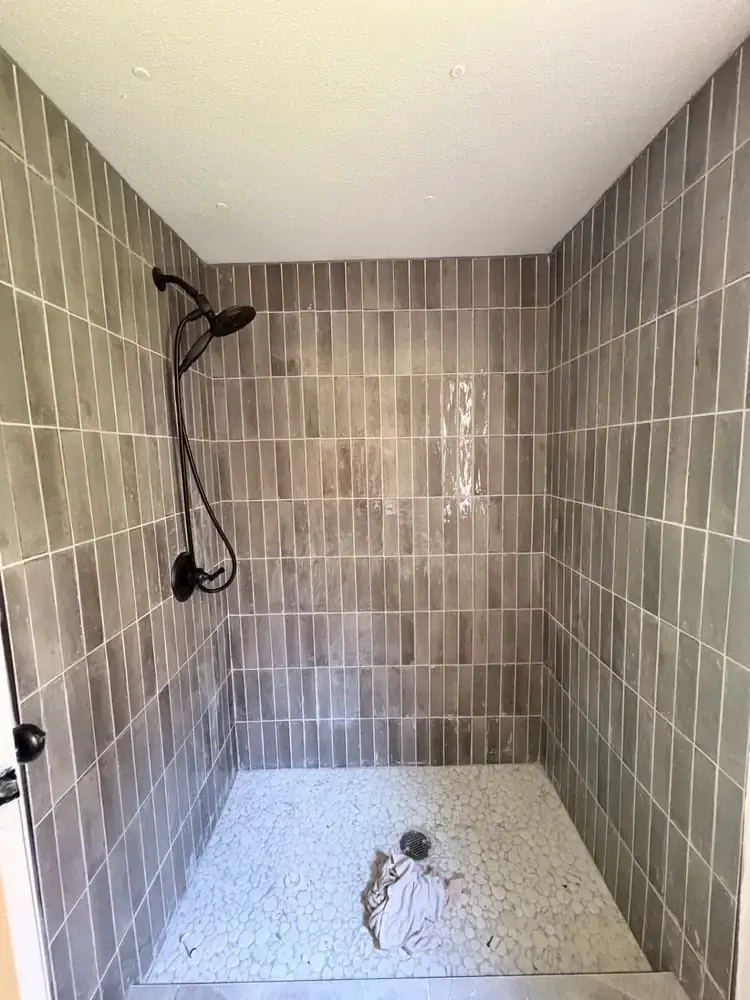 Close view of the tiled walk-in shower with a handheld showerhead at 495 Pack Road in Ranger