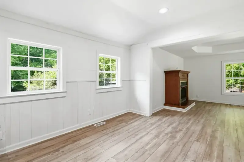 Bright open living area with paneled walls at 497 Pack Road